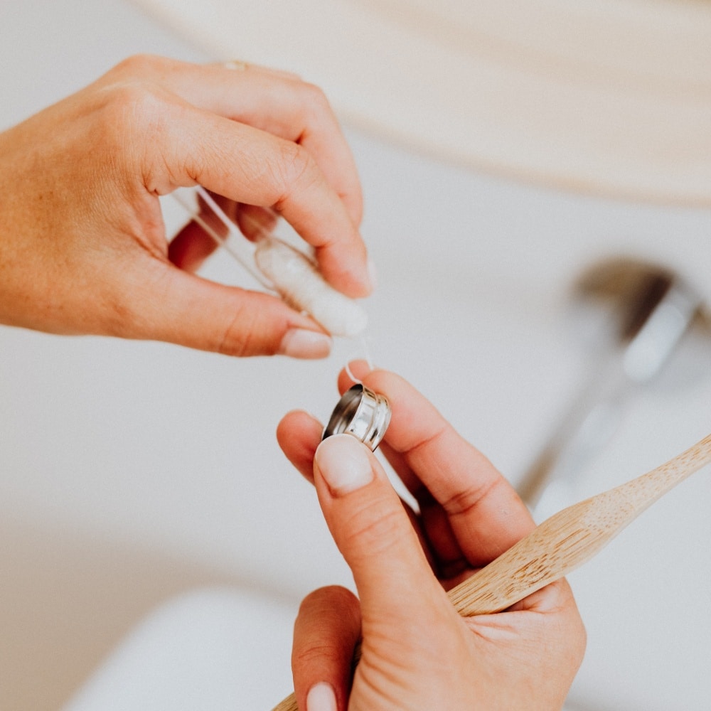 Person holding a dental floss tool