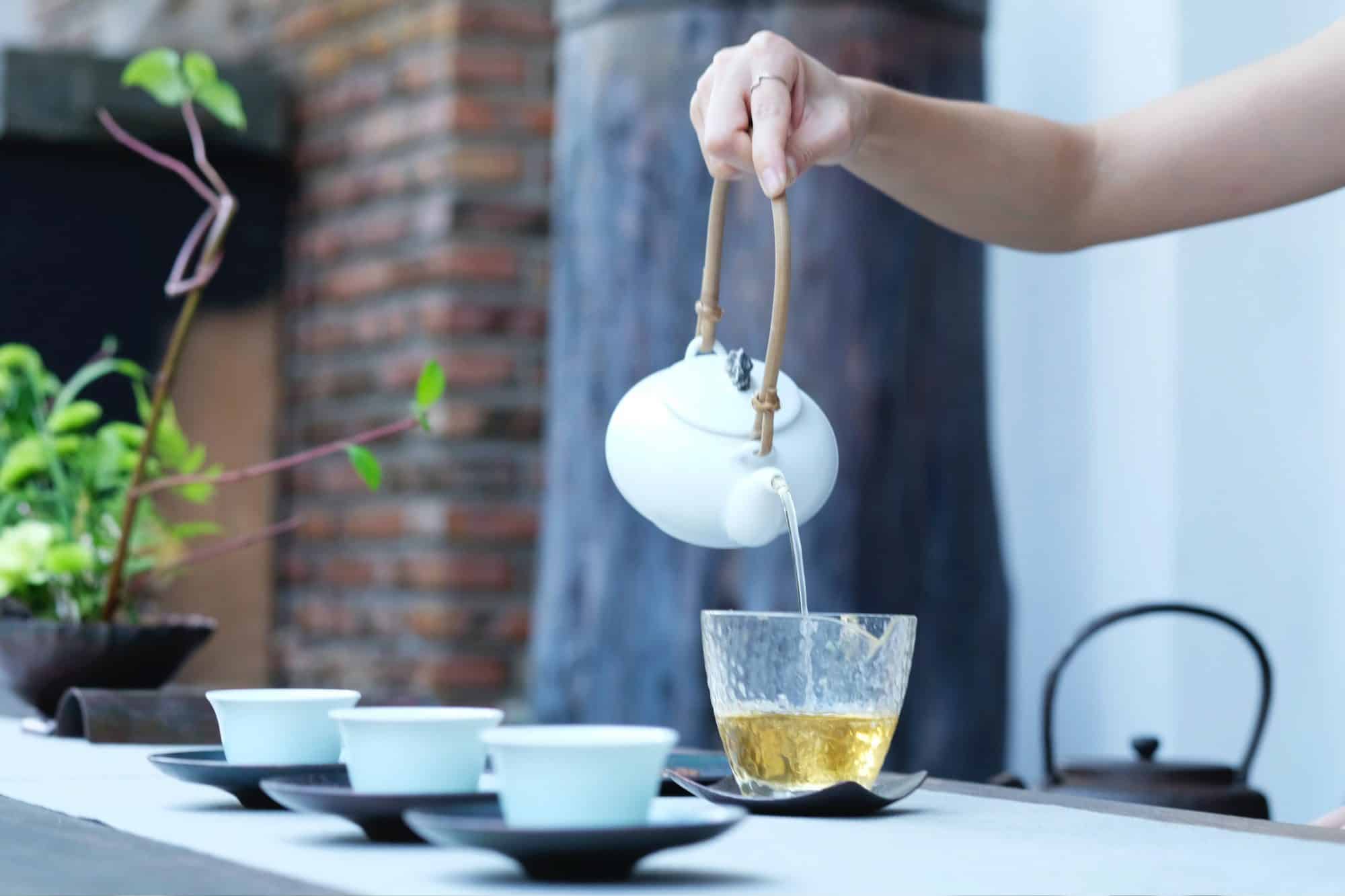 Pouring herbal tea for inflammation into cups