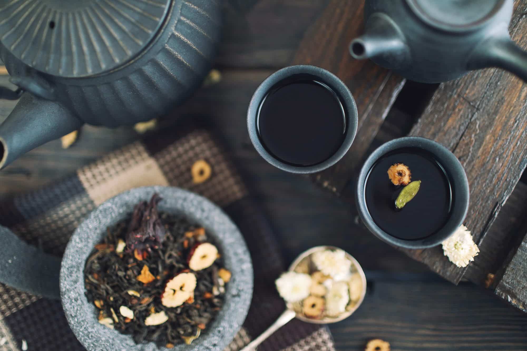 Different teas in cups and teapot
