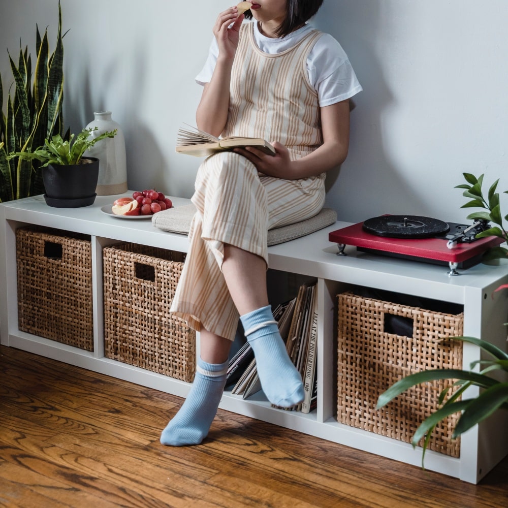Use collapsible storage bin as seating storage