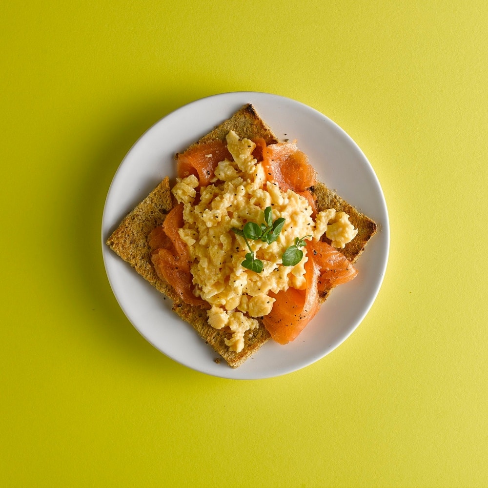 Soft scrambled egg and lox on toast